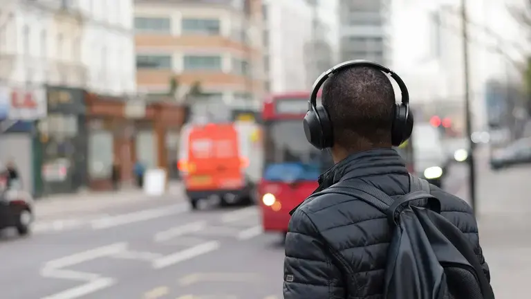 A man wearing wireless headphones