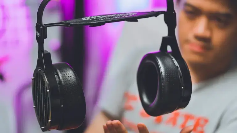Person reaching for headphone