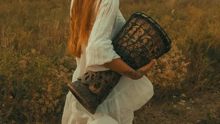 Person walking with a djembe