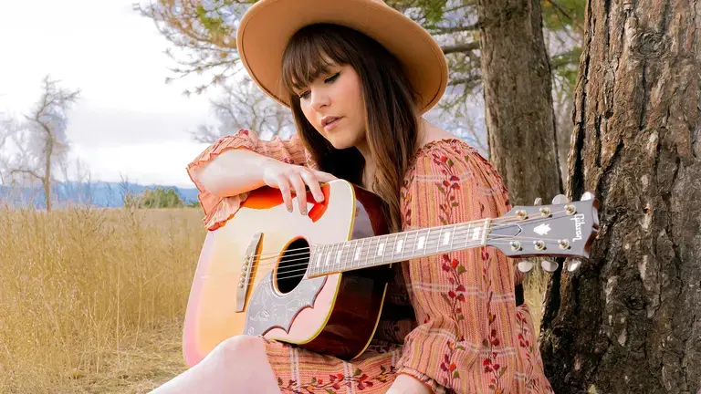 Gibson Acoustic Guitar Played By A Woman