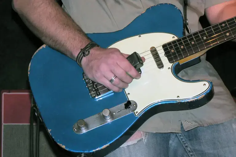 Guitarist using an Ebow