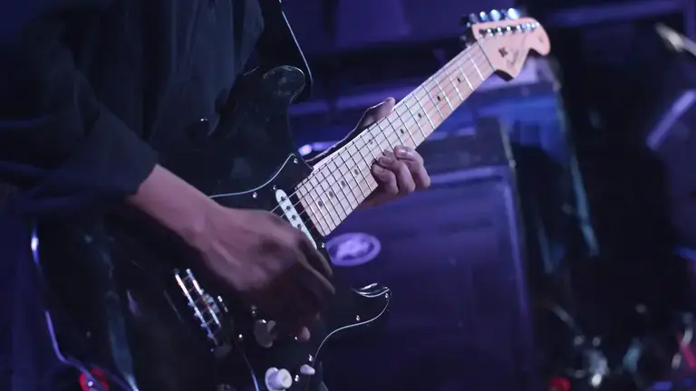 Guitarist in front of an amp
