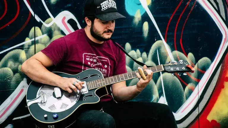 Person playing a resonator guitar
