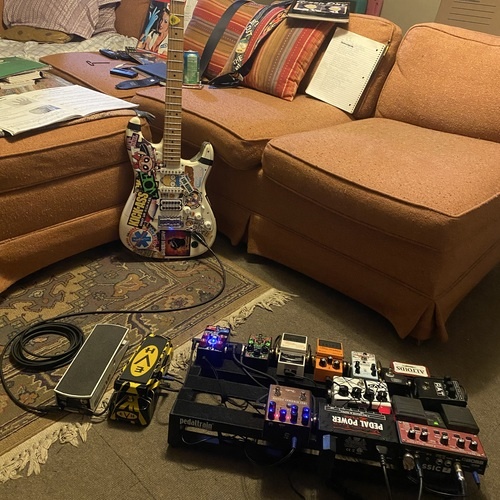 Photo of MXR Dookie Drive and more gear in a pedalboard and guitar
