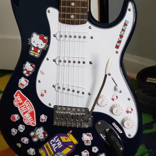 Photo of Silvertone Stratocaster in a guitar and closeup