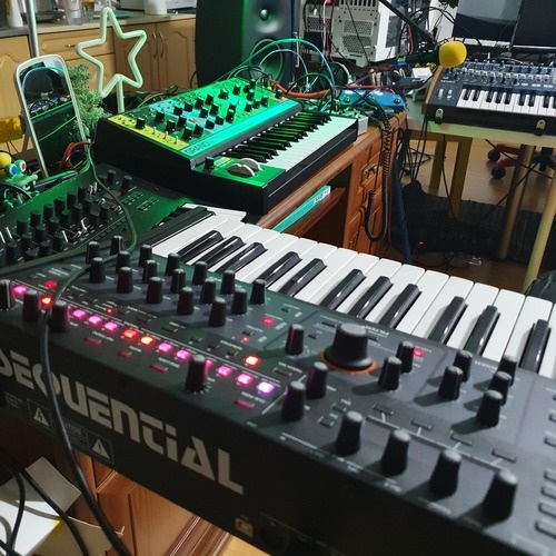 Photo of Sequential Pro-3 and more gear in a studio and synths