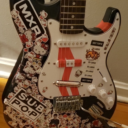 Photo of Silvertone Stratocaster in a guitar and closeup