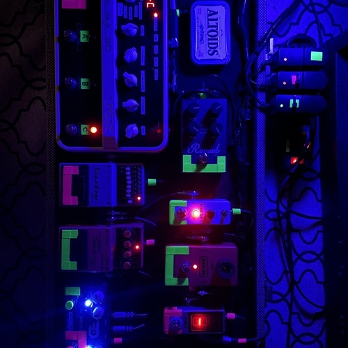Photo of Vox DelayLab and more gear in a pedalboard and guitar
