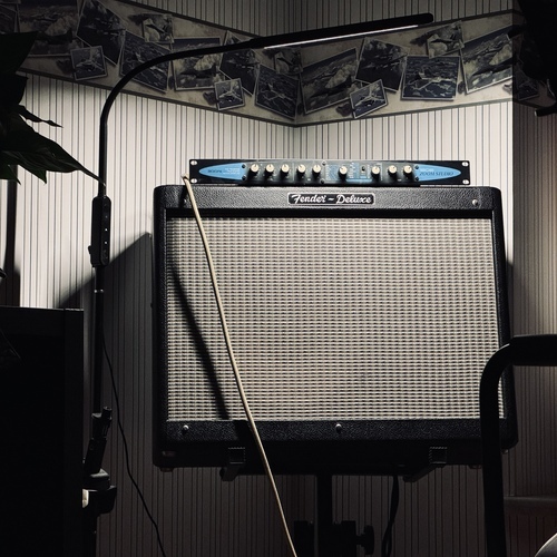 Photo of Zoom Studio 1202 in a studio, guitar, and amplifier