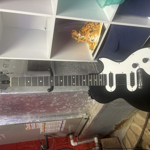 Photo of Epiphone Les Paul SL in a studio, guitar, and live