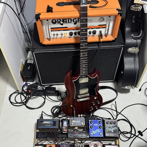Photo of Electro-Harmonix Pulsar and more gear in a pedalboard, guitar, and amplifier