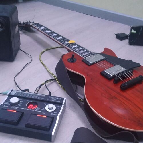 Photo of Korg Ax3g and more gear in a pedalboard, guitar, and amplifier