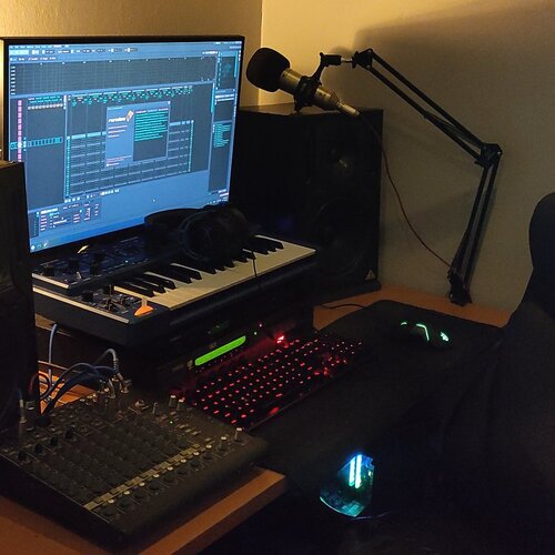 Photo of Renoise and more gear in a studio, synths, and DAW