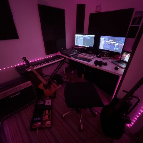 Photo of Apple Logic Pro and more gear in a pedalboard, studio, and guitar