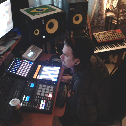 Photo of Ableton Push and more gear in a studio and synths